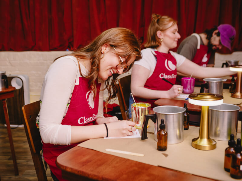 A group of people having fun at a candle making class
